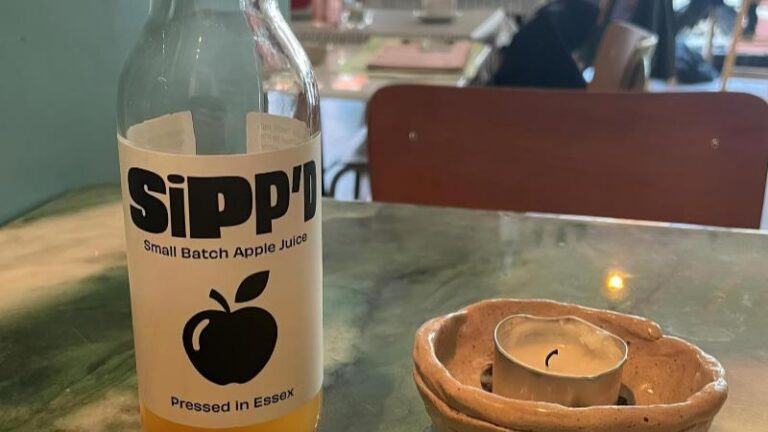 Apple Sipp’d small batch apple juice at Dauns with a candle beside the bottle