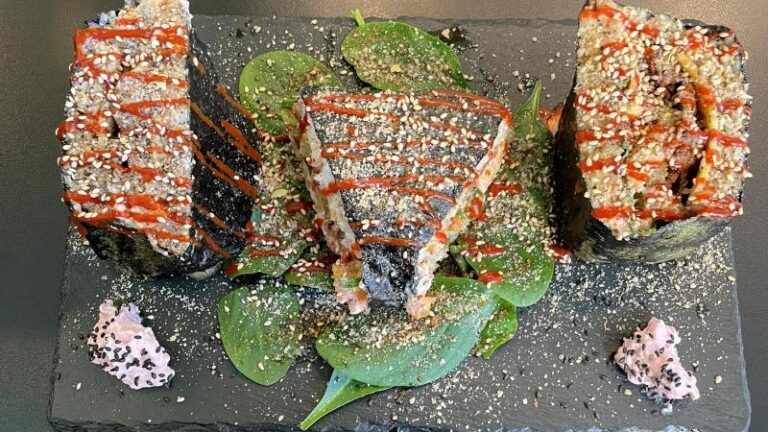 Overhead shot of Sushi Tramezzino with yellow kimchi, beautifully decorated, at Vegan Yes in London