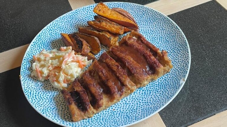 Full plate shot of ASDA OMV BBQ No Ribs with wedges and coleslaw