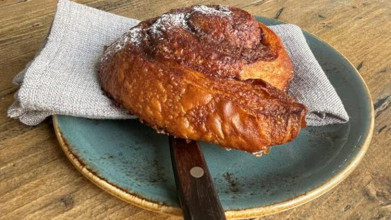 Cinnamon bun on a plate at Cradle in Sudbury