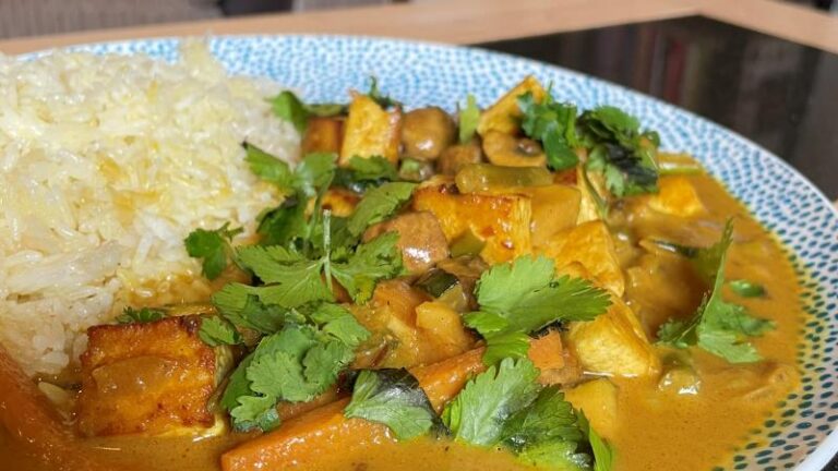 Full plate shot of creamy tofu korma with cardamom butter rice