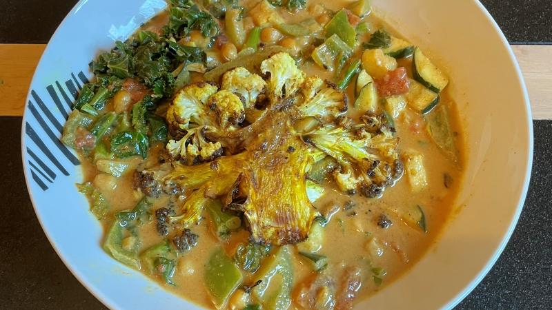 Crispy cauliflower steaks with chickpeas, kale, courgette and creamy coconut curry sauce