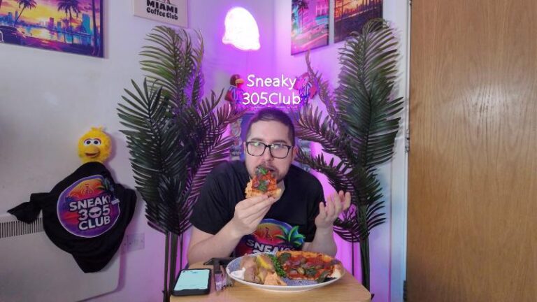 Ian smelling a slice of Crosta & Mollica Vegana Sorrentina pizza before tasting it