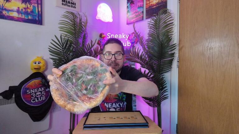 Ian showing the Crosta & Mollica Vegana Sorrentina pizza still wrapped before cooking