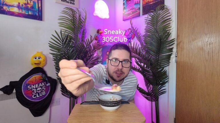 Ian holding a spoonful of Deliciously Ella Almond Butter Protein Granola towards the camera