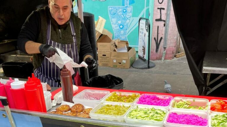 Close-up shot of an Eye Falafel staff member wrapping up a vegan falafel wrap at the street food stall in London