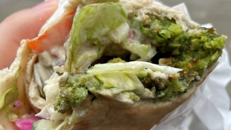 Close-up shot of a vegan falafel wrap from Eye Falafel street food store in London