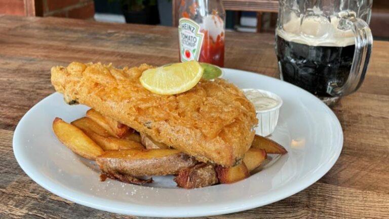 Vegan beer battered tofu and chips with peas, tartar sauce and a drink at Hanks Dirty