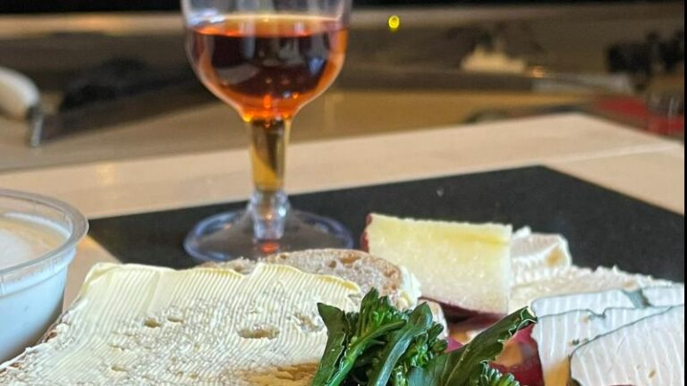 Honestly Tasty vegan cheeseboard with Blue, Bree, Garlic and Herb Dip and a glass of wine