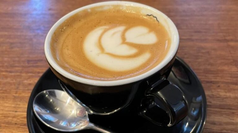 Oat milk flat white with latte art at Honey + Harvey in Colchester