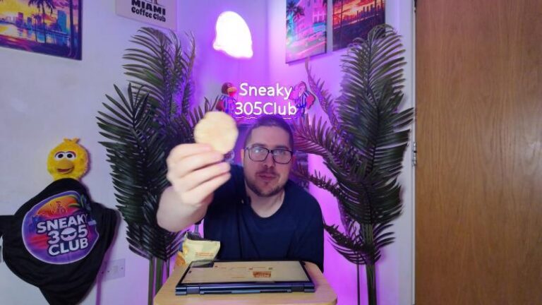 Ian holding a Kettle Honey Dijon Mustard crisp during a Sneaky305Club food review