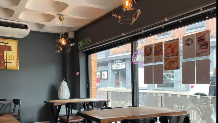 Shot inside Kimchi House in Colchester showing the table and seating looking out onto Queen Street