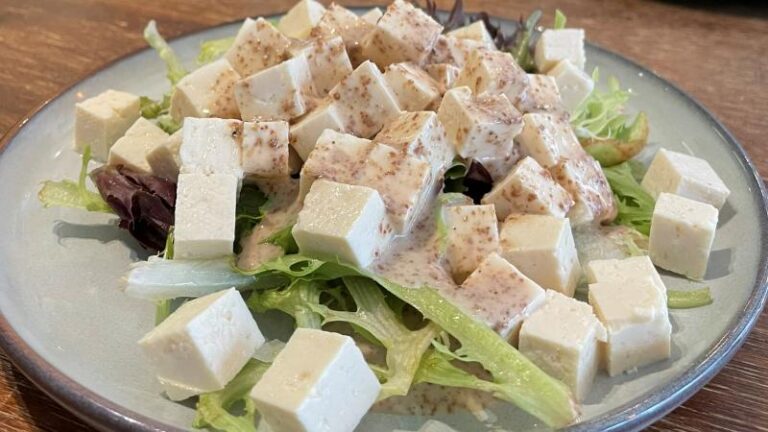Full-size shot of a plate of tofu salad with dressing over the top at Kimchi House in Colchester