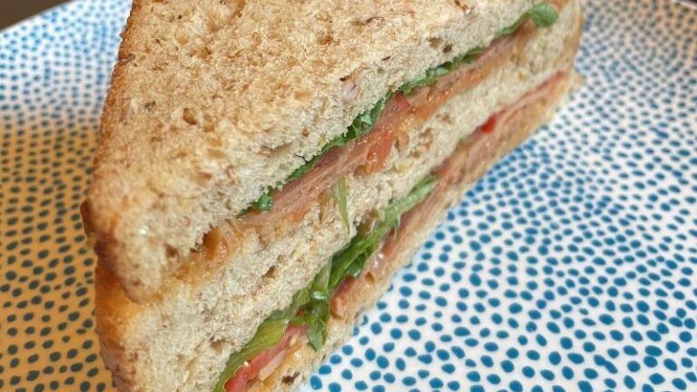 Close-up shot of a La Vie vegan VLT sandwich on a plate