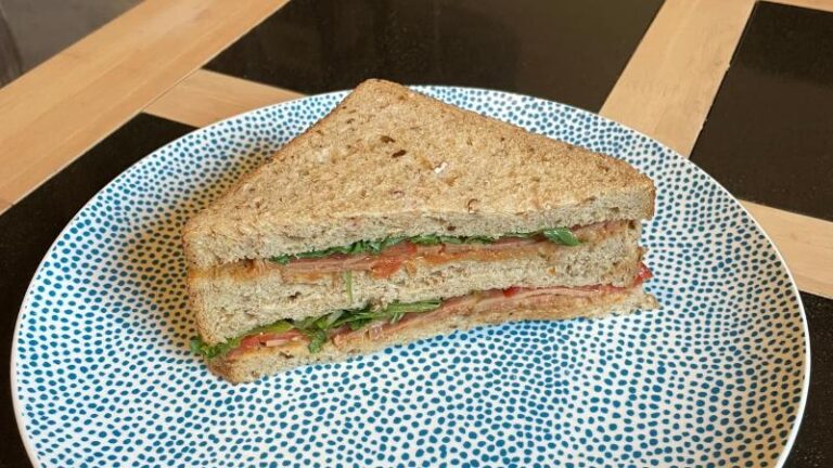 Shot of a La Vie vegan VLT sandwich out of its wrapper and stacked on a plate