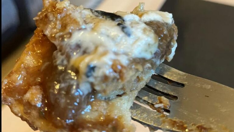 Forkful of Magpye and Honestly Tasty Steak and Blue Cheese Pie with gravy and melted vegan blue cheese