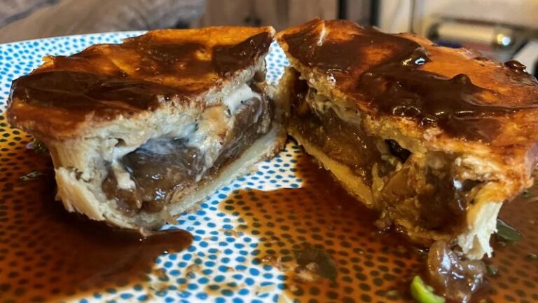 Inside of the Magpye and Honestly Tasty Steak and Blue Cheese Pie with gravy and melted vegan blue cheese