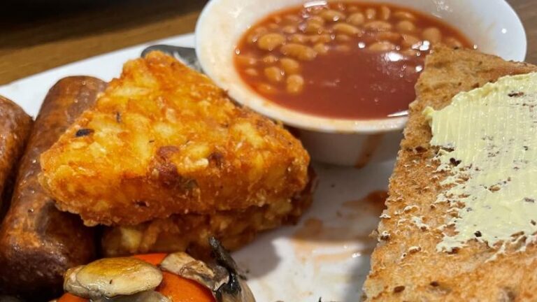 Close-up of breakfast at Mill Races in Aldham near Colchester showing a hash brown, baked beans and vegan buttered toast
