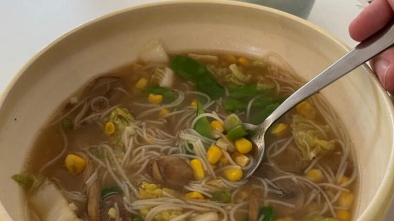 Close-up of miso sweetcorn chowder with a spoon in the bowl at The Commons Cafe in Colchester