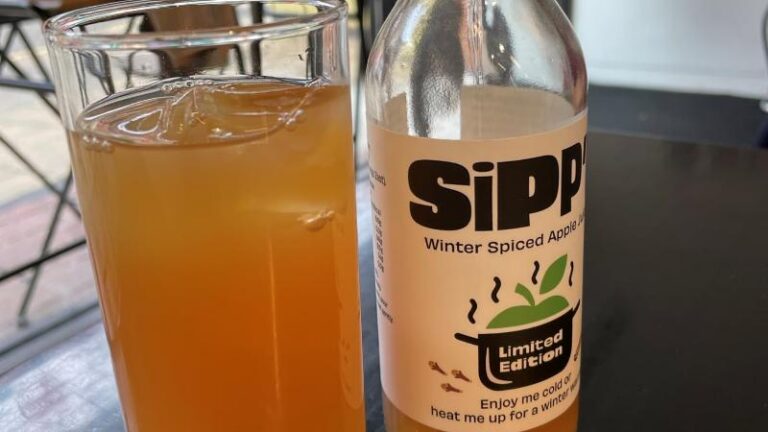 Bottle of Apple Sipp’d drink beside a glass cup with the drink poured inside at Patch in Colchester