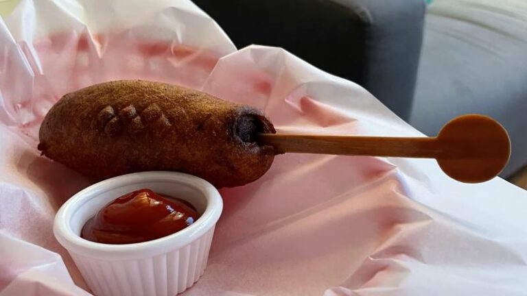 Picture of a vegan corn dog with tomato ketchup from Piehole Pizzas in Southend