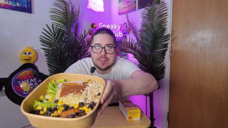 Ian holding the Pollen + Grace Mexican Smoky Chipotle Black Bean Burrito Bowl close up to the camera