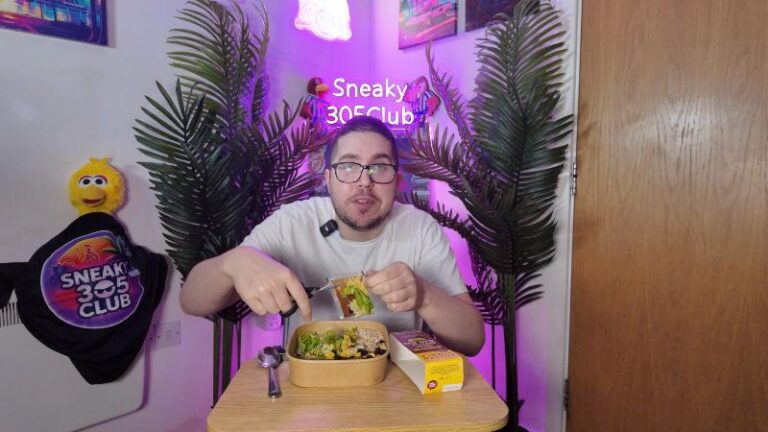 Ian cutting open the sauce packet for the Pollen + Grace Mexican Smoky Chipotle Black Bean Burrito Bowl