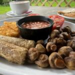 Full plate shot of vegan breakfast with oat milk cappuccino and toast at Shoulder of Mutton near Colchester