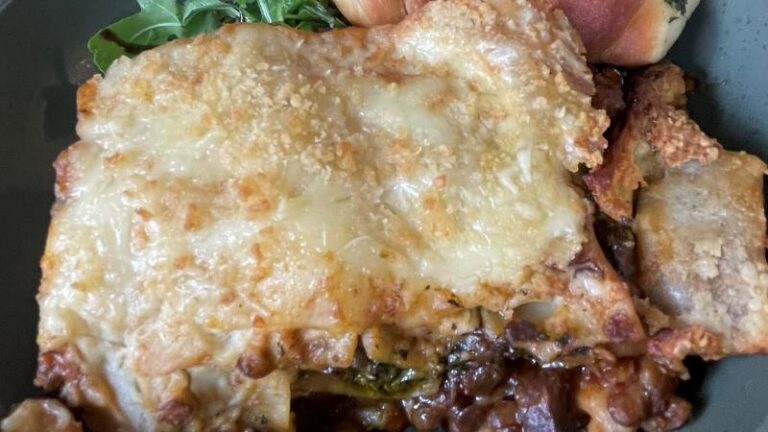 Full-size shot of pumpkin and kale lasagne at The Greenhouse Café in Felixstowe, served with fresh rocket salad and homemade garlic knots