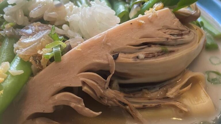 Close-up of banana blossom in coconut milk curry sauce at Tayo By Bien in Colchester