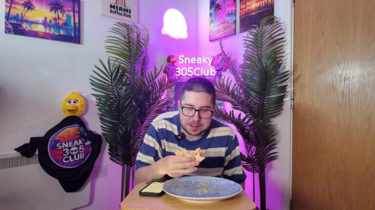 Ian eating the Tesco Beechwood Ham Egg and Chips Sandwich while looking down at it with a confused reaction