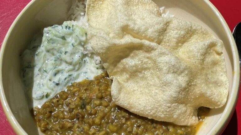 Close-up of mung bean curry with rice and poppadoms at The Commons Café in Colchester