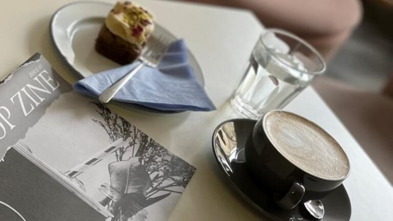 Table shot with oat milk flat white and chai cake at The Hop Coffee in Sheffield