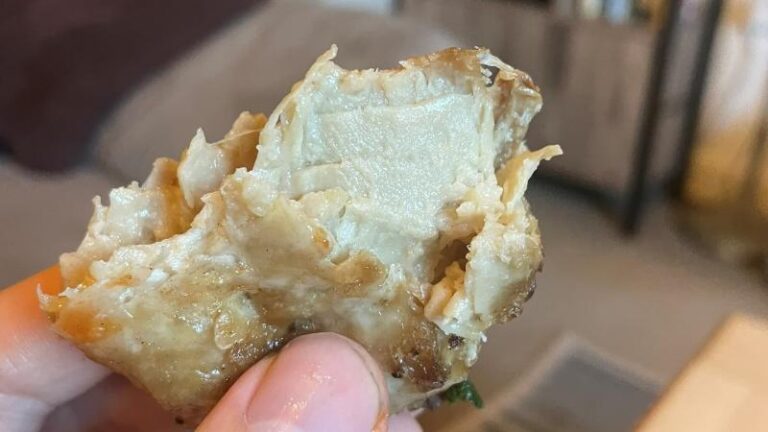 Picture of cooked THIS Isn’t vegan chicken thighs after a bite has been taken to show the texture inside