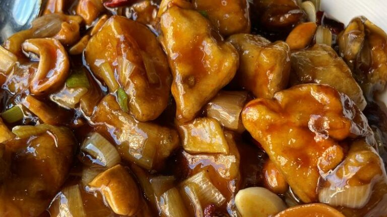 Close-up of Tofu Vegan Gong Bao vegan chicken in a glossy sauce with cashews and vegetables
