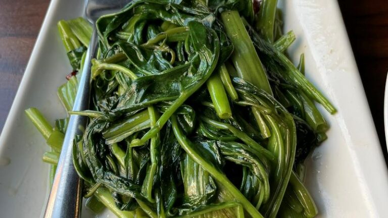Close-up of stir-fried water spinach with chilli and Sichuan pepper at Tofu Vegan