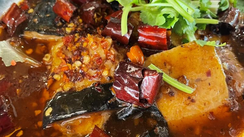 Close-up of vegan fish in chilli oil at Vegan Planet in Camden, London