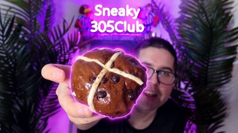 Ian holding a Waitrose No.1 Belgian Chocolate Hot Cross Bun close to the camera