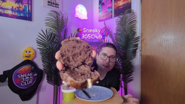 Ian showing the inside of a Waitrose No.1 Belgian Chocolate Hot Cross Bun close up to the camera