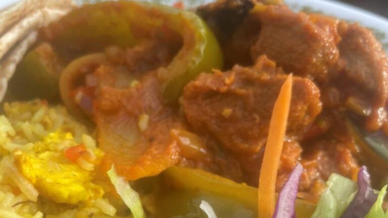 Close-up of Jomidar Mahal Lahori lamb curry with peppers, onions and rice