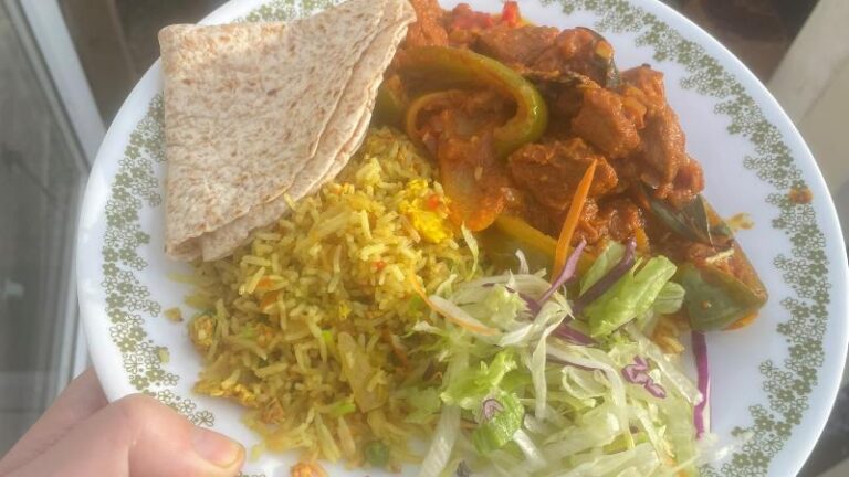 Jomidar Mahal Lahori lamb curry served with rice, chapati and salad on a plate
